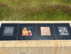 Memorial with photo of man named Dennis in front of flowery, tall grass at Eldridge Memorial